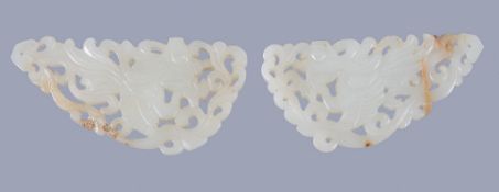 A pair of Chinese white jade 'Aspara' plaques , the figures pierced and carved amidst trailing