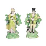 A pair of Staffordshire pearlware figures of a sportsman and companion , circa 1815, standing