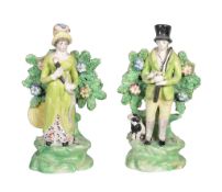 A pair of Staffordshire pearlware figures of a sportsman and companion , circa 1815, standing