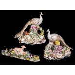 A pair of English porcelain flower encrusted models of peacocks, circa 1830, Minton or Derby, blue