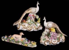 A pair of English porcelain flower encrusted models of peacocks, circa 1830, Minton or Derby, blue