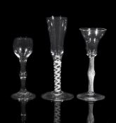 A plain-stemmed wine glass, mid 18th century, the ovoid bowl supported on a centrally knopped stem