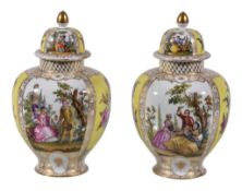 A pair of Dresden porcelain vases and covers, late 19th century, typically decorated with alternate