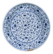 A Chinese blue and white dish, decorated with stylised lotus flowers and scrolling foliage, 38.2cm