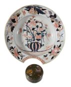 A Japanese Imari barber s bowl, Arita, circa 1700, painted with flowers and the border with raised