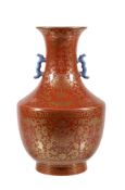 A Chinese coral-ground two-handled vase, painted in gilt with flower heads and scrolling foliage