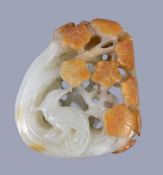 A Chinese pale celadon and russet jade 'magpie and prunus' pendant, 5cm high x 4.2cm wide