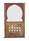 A Moroccan carved hardwood and painted wall mirror, 19th century and later, 128cm high, 76cm wide