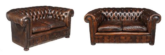 A pair of leather button upholstered chesterfield sofas in Victorian style , 20th century, each