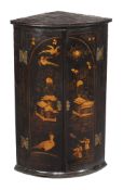 A George II black lacquer and gilt chinoiserie decorated hanging corner cupboard , circa 1740, of
