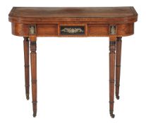 Ω A Regency mahogany ebony strung and gilt metal mounted folding table , circa 1820, the rosewood