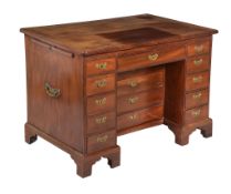 A George III mahogany kneehole desk , circa 1760, the cleated rectangular top hinged to be raised