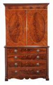 A George IV mahogany and satinwood strung clothes press, circa 1825, Channel Islands, the bead