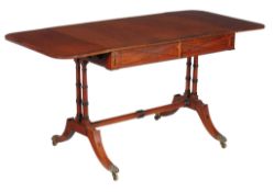Ω A Regency mahogany and rosewood banded sofa table, circa 1820, with ebony inlay in the manner