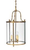 A gilt metal and glazed cylindrical hall lantern, early 20th century, with three bowed glass panes