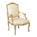 A Louis XV giltwood and yellow & cream damask upholstered armchair , mid 18th century, 98cm high,