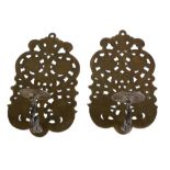 A pair of brass wall appliques in 17th century style, early 20th century, the sockets on scrolling