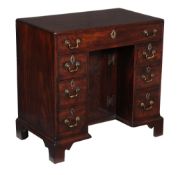 A George III mahogany kneehole desk, circa 1780, the rectangular caddy moulded top above an
