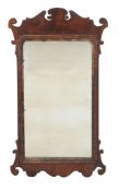 A George III walnut fretwork wall mirror, circa 1770, with parcel gilt slip, 87cm high, 50cm wide