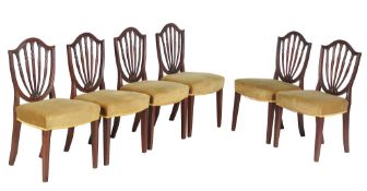 A set of six George III mahogany dining chairs , circa 1790, each with a shield backs