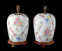 A pair of Continental enamel painted porcelain jars in famille rose style, early 20th century and