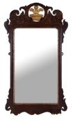 A George III mahogany and parcel gilt fretwork mirror , late 18th century, the surmount with