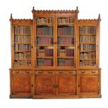 A Victorian oak breakfront bookcase in the Gothic revival taste , circa 1880, the stepped