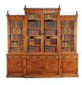 A Victorian oak breakfront bookcase in the Gothic revival taste , circa 1880, the stepped