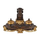 A French patinated and parcel gilt bronze encrier in Neoclassical taste, circa 1875, the shaped