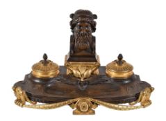 A French patinated and parcel gilt bronze encrier in Neoclassical taste, circa 1875, the shaped