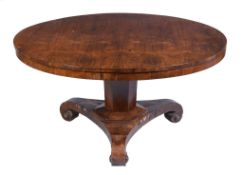 Ω A William IV rosewood centre table , circa 1830, the bookmatched top above facetted pillar and