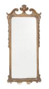 A George II giltwood and gesso wall mirror, circa 1735, the rectangular plate within a moulded
