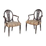 A pair of George III mahogany armchairs, circa 1770, after a design by Thomas Hepplewhite, each