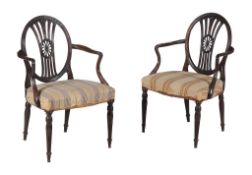 A pair of George III mahogany armchairs, circa 1770, after a design by Thomas Hepplewhite, each