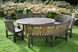 A hardwood garden dining table, modern, of circular form and slatted construction, 74cm high, 180cm