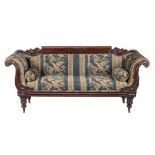 A Victorian mahogany and upholstered sofa, circa 1850, the scrolling showframe above lappet carved