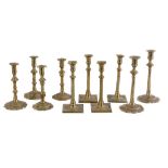 Three pairs of George II brass candlesticks, mid 18th century, with knopped shafts and lobed bases,