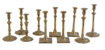 Three pairs of George II brass candlesticks, mid 18th century, with knopped shafts and lobed bases,