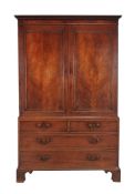 A mahogany linen press , early 19th century, the panel doors enclosing later hanging rails, 205cm