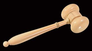 Ω A Victorian turned ivory gavel, mid 19th century, the baluster handle with ebonised knop and bead