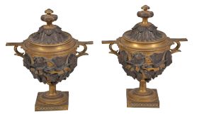 A pair of Continental parcel gilt and patinated bronze twin handled urns and covers, circa 1895, in