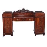 A George IV mahogany pedestal sideboard, circa 1825, the acanthus and twin scroll carved cresting