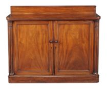 An early Victorian mahogany side cabinet, circa 1840, the panel doors enclosing two banks of