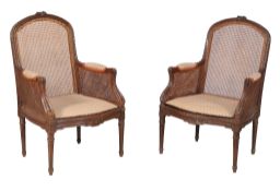 A pair of stained wood bergere armchairs in Louis XVI style, early 20th century