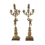 A pair of Empire gilt bronze four light figural candelabra, early 19th century, each with a Campana