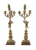 A pair of Empire gilt bronze four light figural candelabra, early 19th century, each with a Campana