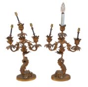 A pair of Regency or George IV gilt bronze three light candelabra, circa 1820, with foliate cast