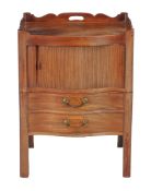 A George III mahogany night commode , circa 1780, of serpentine outline, the tambour front