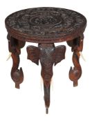 Ω An Indian carved hardwood and ivory mounted occasional table, circa 1880, profusely carved