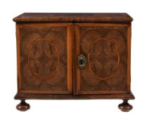 A William & Mary walnut and olivewood oyster veneered table top cabinet, circa 1690, with holly
